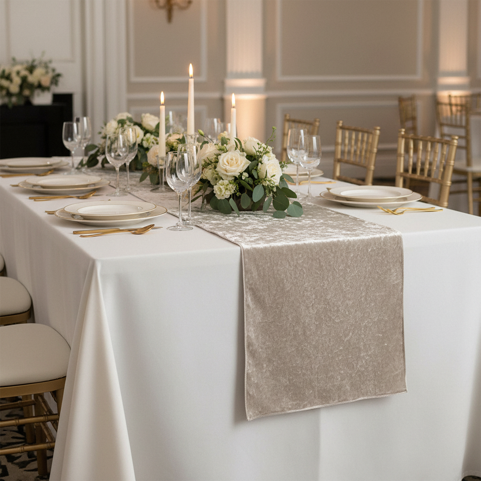 Velvet Table Runner Taupe on an ivory rectangular tabelcloth with white dinner plates, tapered candles and floral centerpieces
