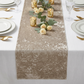 Velvet Table Runner Taupe  on a white tablecloth with votive candled and roses and greenery centerpieces