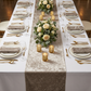 Velvet Table Runner Taupe  on a white tablecloth with votive candled and roses and greenery centerpieces