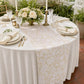 birdseye view of the Vintage Lace Print Scuba Table Runner Champagne/White on top an ivory round table