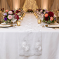 Vintage Veil Embroidery Table Runner White top of a white tablecloth for a wedding table setting, paired with colorful floral centerpieces, gold chargers, and tea light candles
