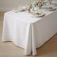 Scuba King 108"x156" Rectangular Tablecloth White table setting floral centerpieces, white dinnerware, and wine glasses