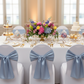 Wide Satin Chair Sash - Dusty Blue on white chair cover | white tablecloth | gold trimmed charger plate | white dinner plate | white napkin