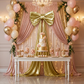 XL Giant Fabric Bow for Backdrop Metallic Gold against blush/rose gold drape panels behind a dessert table
