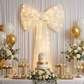 XL LED Chiffon Bow for Backdrop Ivory on a backdrop with white backdrop drapes 
