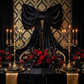 XL Velvet Giant Fabric Bow for Backdrop Black paired with Gold/Black backdrop behind a bridal table
