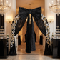 XL Velvet Giant Fabric Bow for Backdrop Black on a curved arch with black glitz drapes and silver and gold ribbons
