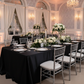 Silver and black wedding with the black premium satin wrinkle resistant rectangular tablecloth and silver chiavari chairs
