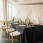 Brunch gathering with Black Premium Satin Wrinkle-Resistant Rectangular Tablecloth, sheer draping, gold chiavari chairs and white charger plates