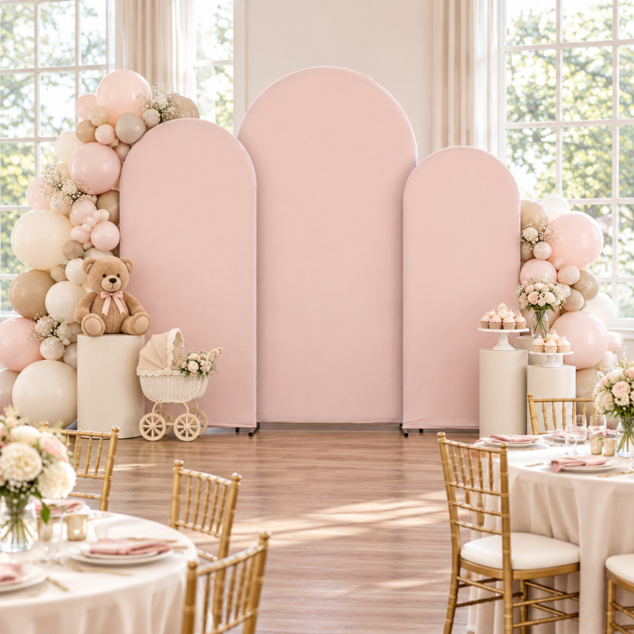 Front-facing blush arch baby shower scene