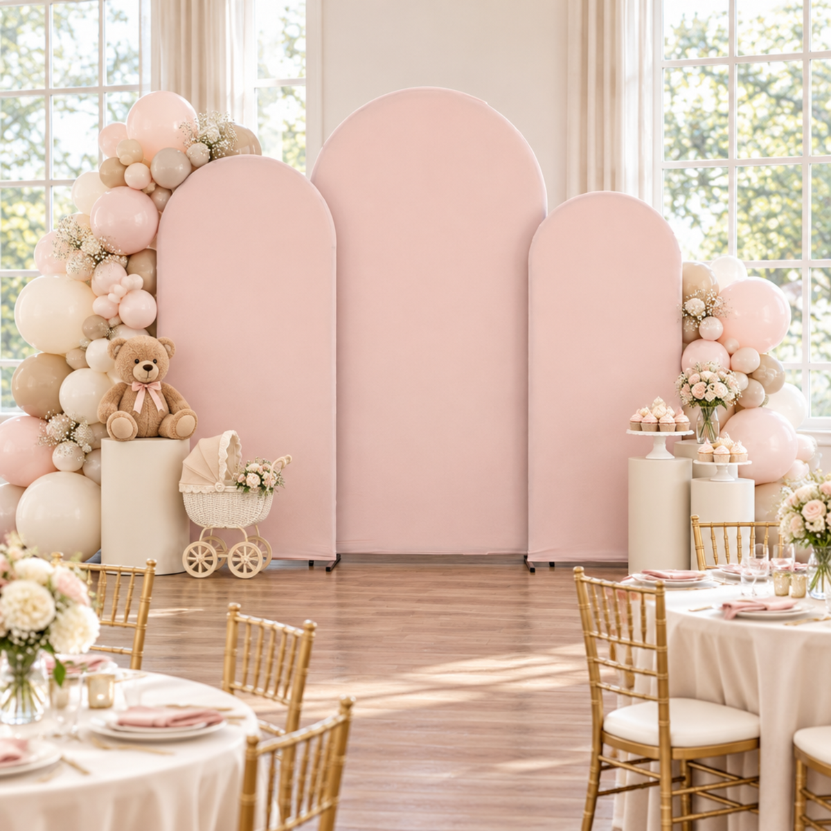 Front-facing blush arch baby shower scene