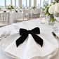 Bright indoor gala with black velvet bow-tie napkin ring
