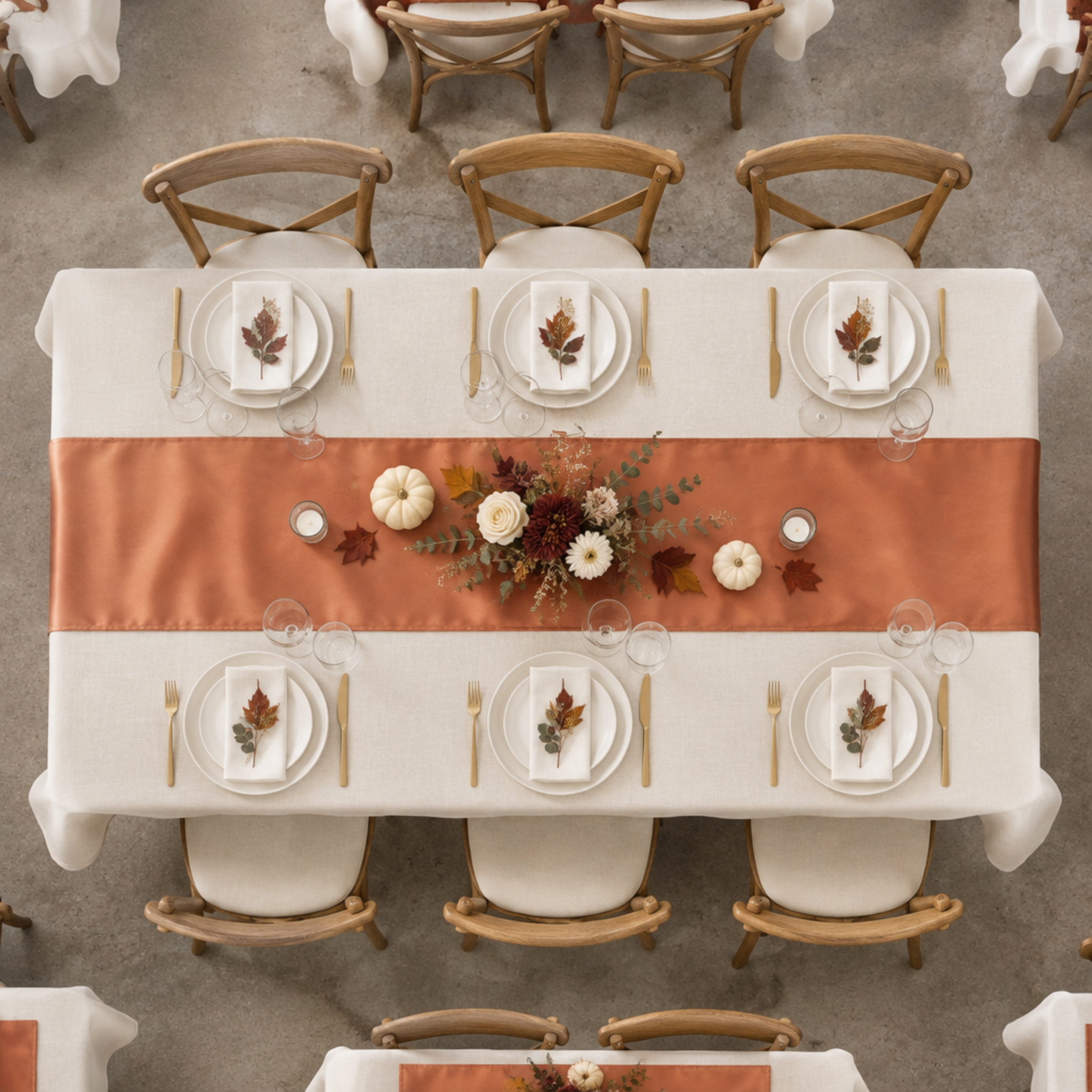Top-down fall event table with terracotta satin runner