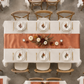 Top-down fall event table with terracotta satin runner