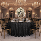 Geometric Glitz Art Deco Sequin Tablecloth 132" Round - Black with Chiavari Gold Chairs.