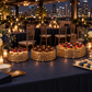 Gold cake stands at a rooftop gala dessert table