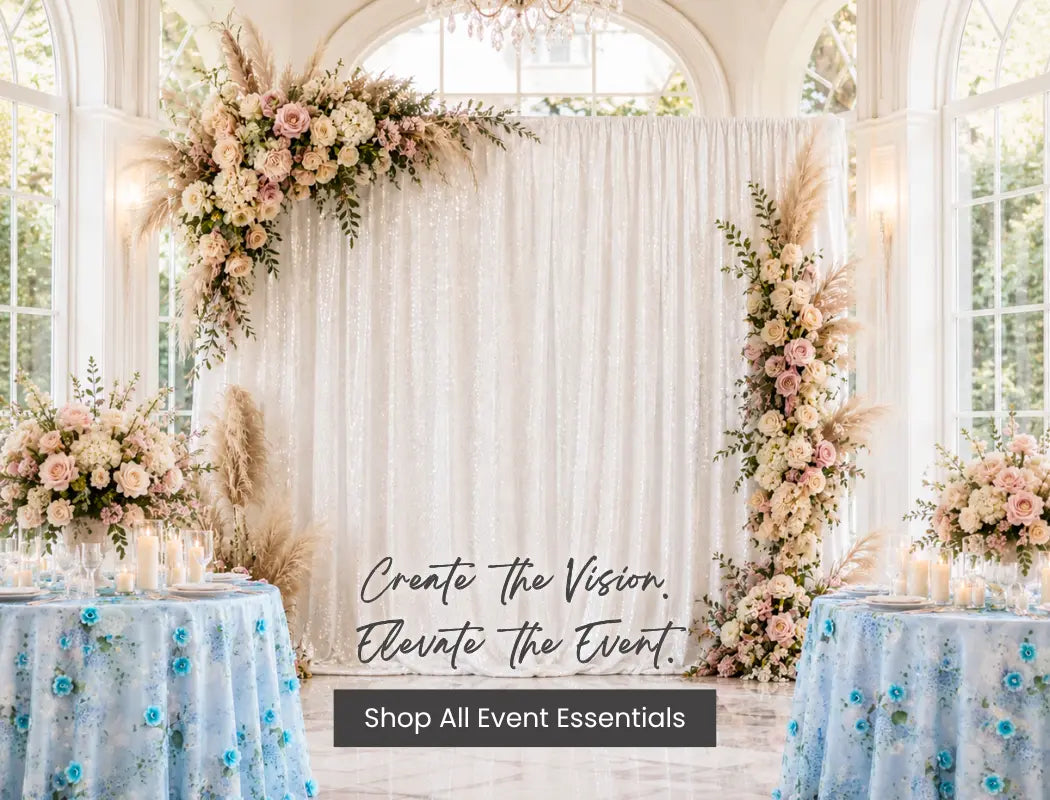 Elegant wedding backdrop with white sequin drape and pastel floral arch, paired with blue table decor for a reception.