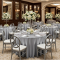 Indoor banquet hall with silver satin tablecloths