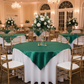 Indoor banquet hall with emerald green satin overlays