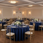 Indoor Banquet Hall with Navy Blue Satin Tables