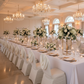 Indoor wedding reception banquet hall with ivory swag back ruched banquet chair cover