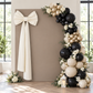 Ivory giant fabric bow positioned off center on an asymmetrical balloon backdrop