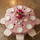 Lamour Satin 120" Round Tablecloth - Dusty Rose/Mauve with Chiavari Gold Chairs in Bird's Eye View Point.