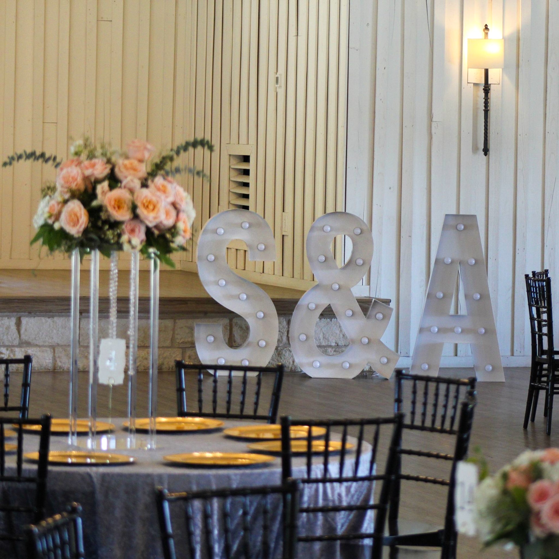 Large 4ft Tall LED Marquee Letter - A with tables and chiavari black chairs.