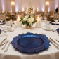 Reef Acrylic Charger Plate - Navy Blue with Round and Chiavari Gold Chairs.