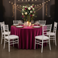 Velvet 120" Round Tablecloth - Magenta with Chiavari White Chairs.