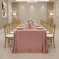 Velvet 90"x132" Rectangular Tablecloth - Dusty Rose/Mauve with Chiavari Gold Chairs.