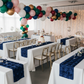 Navy blue rosette satin table runner on birthday celebration tables