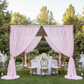 Outdoor garden event with pink voile drapes