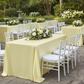 Outdoor garden wedding event setup with yellow satin tablecloth