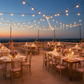 Outdoor terrace evening event with dusty rose Chiavari seat pad covers