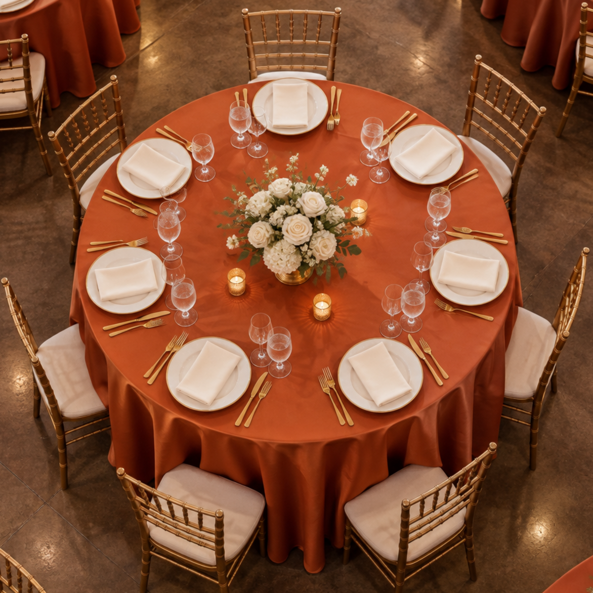 Overhead view of rust satin tablecloth at a banquet