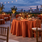 Wide view of rust satin tablecloth at a rooftop dinner