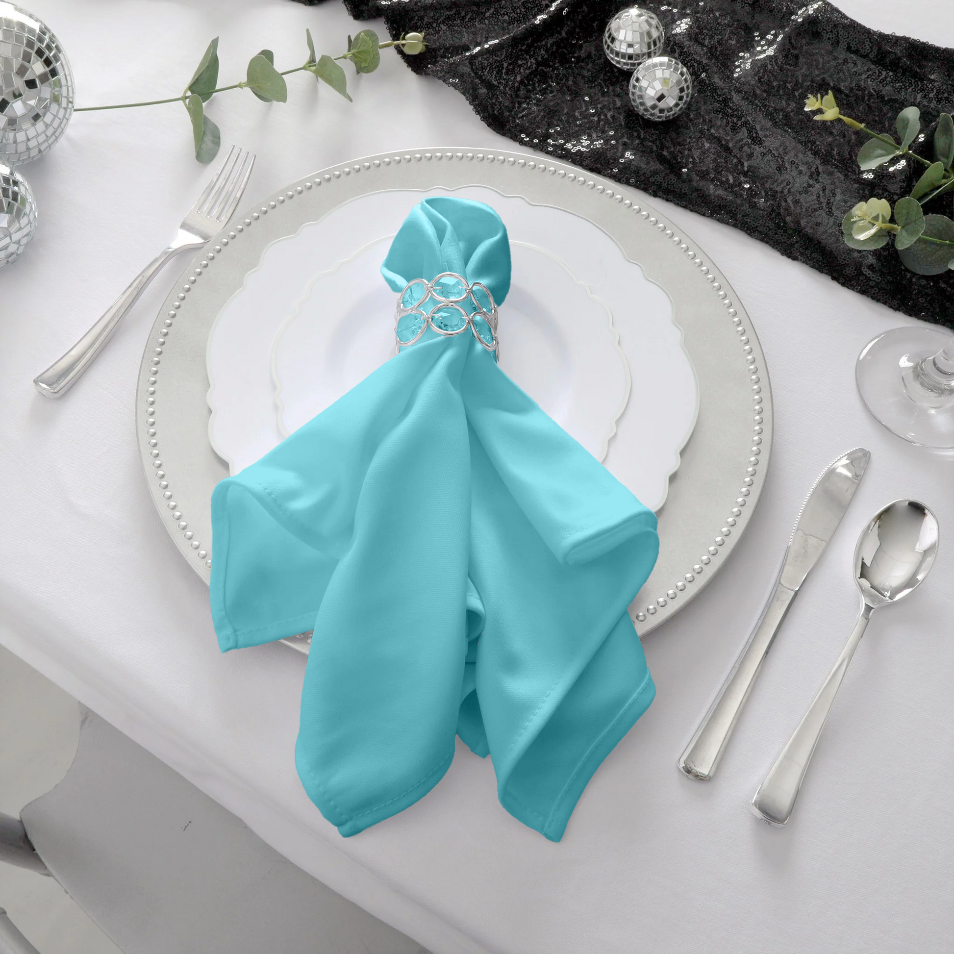 Scuba napkin 20"x20" turquoise on white charger plate with silver crystal napkin ring
