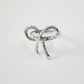 Close-up of silver metal rope bow tie napkin ring detail