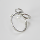 Side view of silver rope bow tie napkin ring showing full circular ring shape