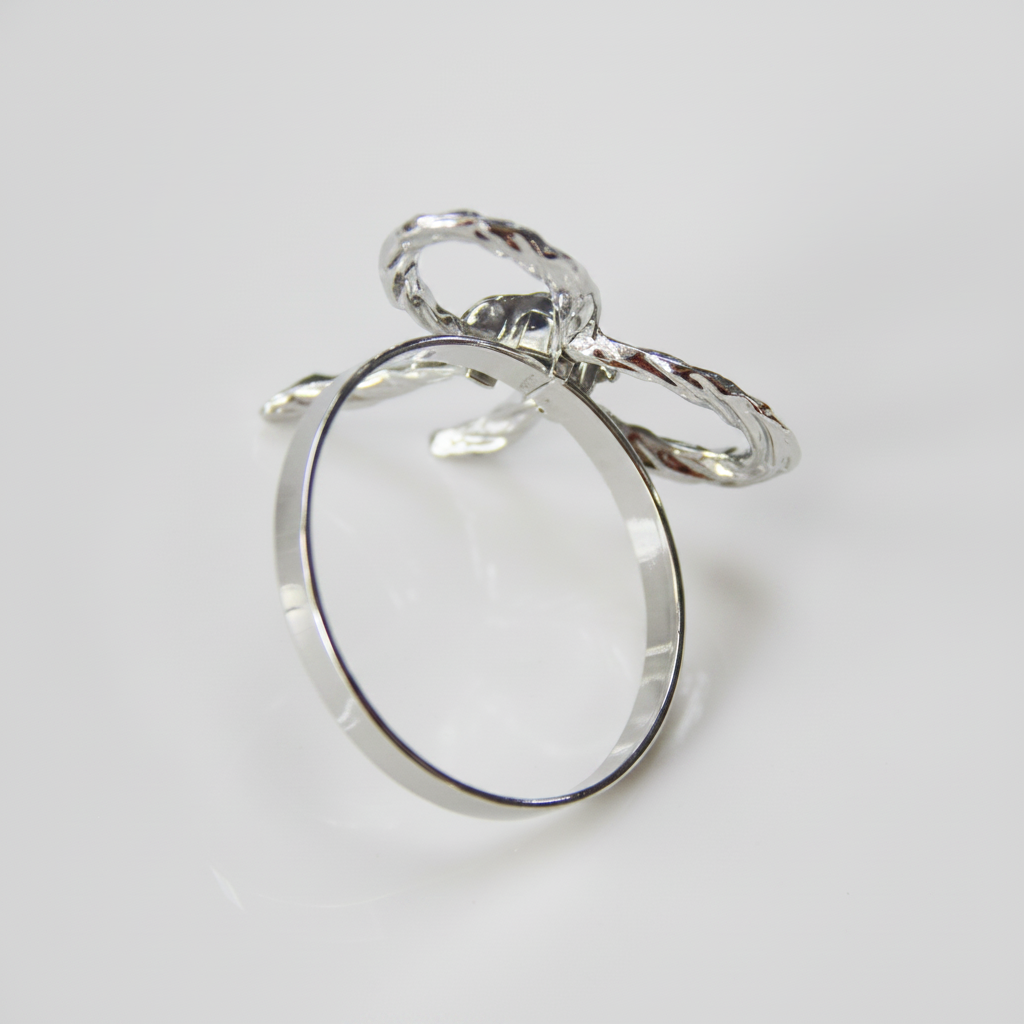 Side view of silver rope bow tie napkin ring showing full circular ring shape