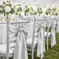 Silver satin chair sashes on chiavari chairs at a tented wedding