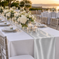 Silver satin table runner on a terrace reception table