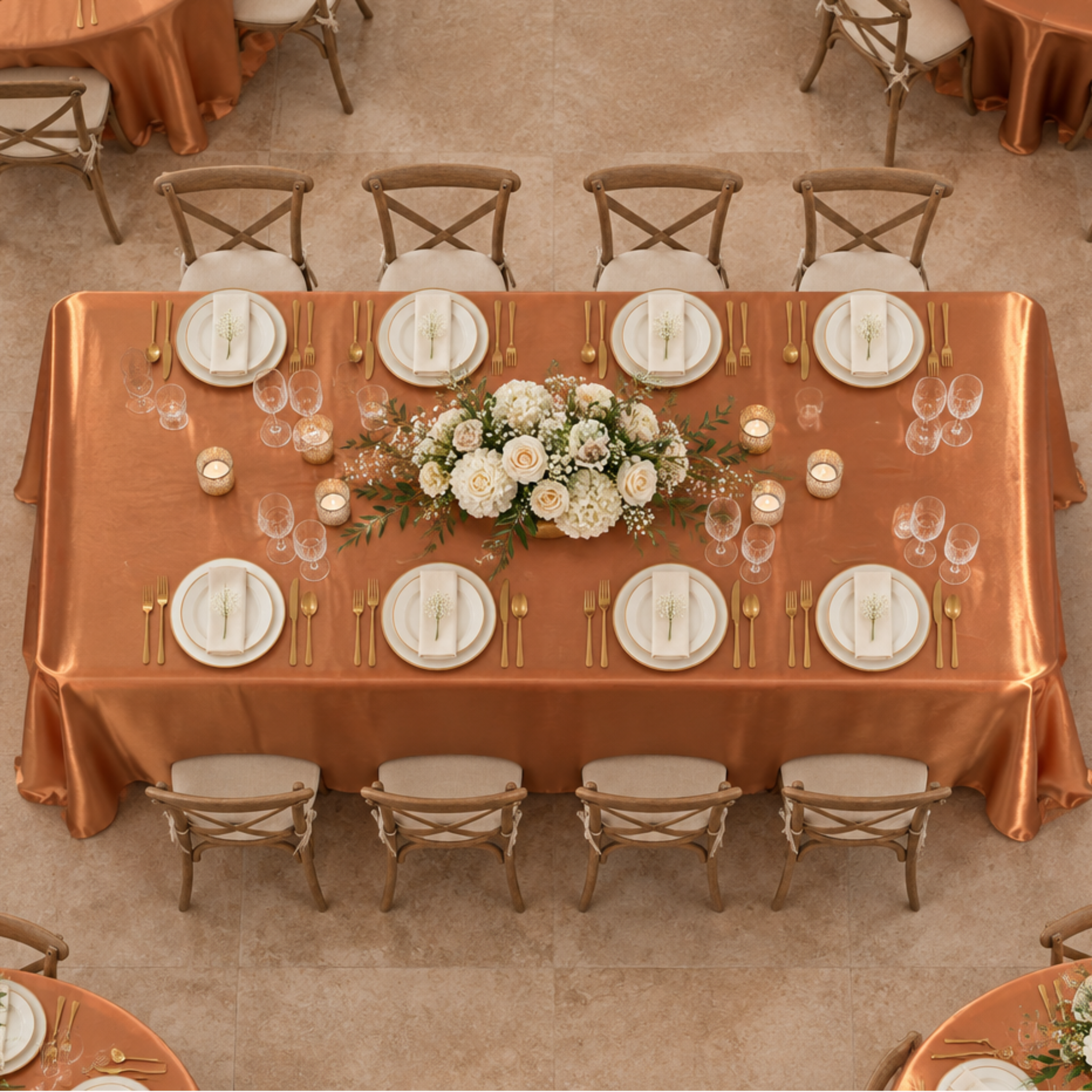 Overhead view of terracotta satin tablecloth at an indoor reception