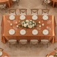 Overhead view of terracotta satin tablecloth at an indoor reception