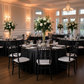 Brunch event with black premium satin wrinkle resistant round tablecloths, water goblets, black chiavari chairs and votive candles